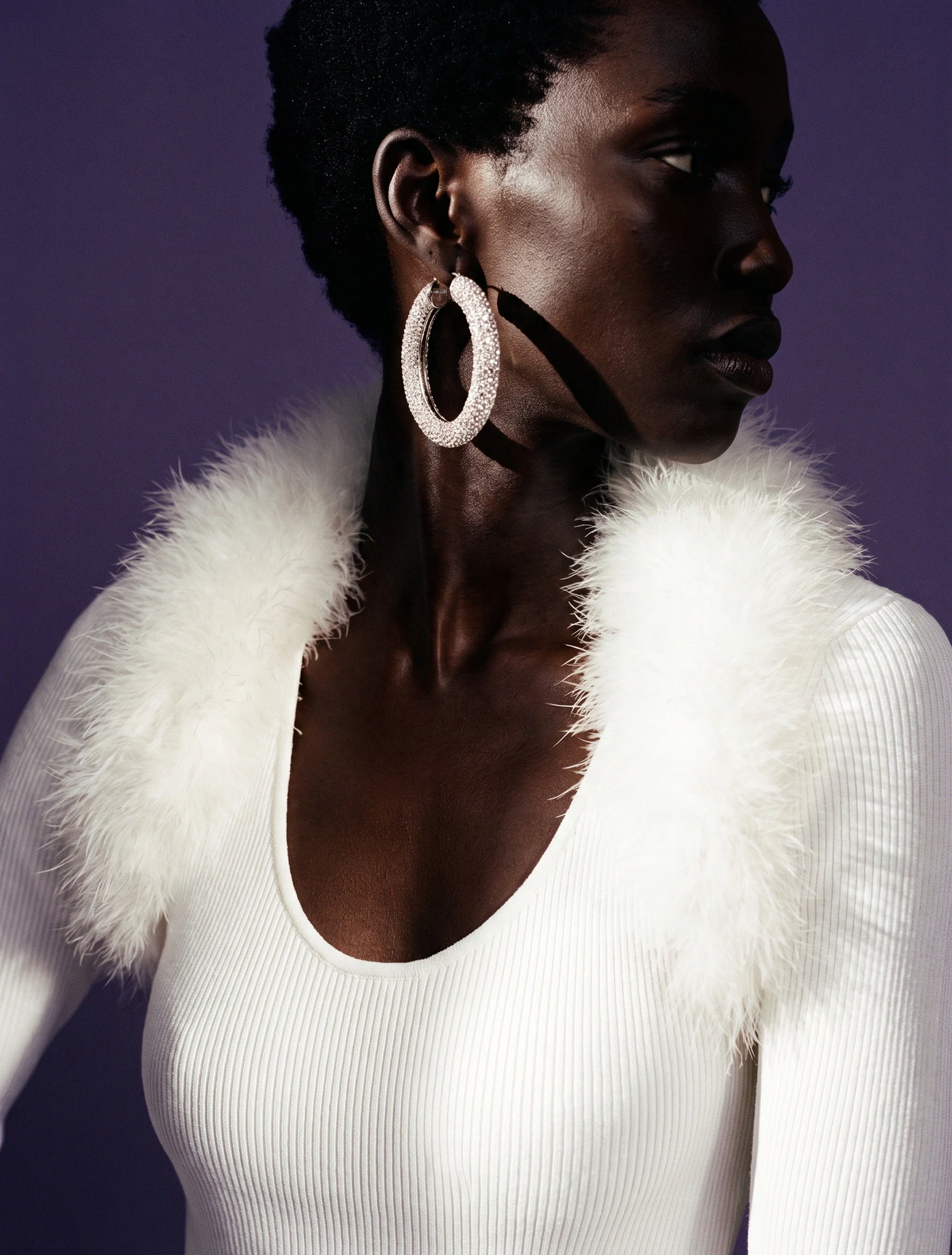 AI-generated on-model image: white knit with a marabou collar in profile against purple