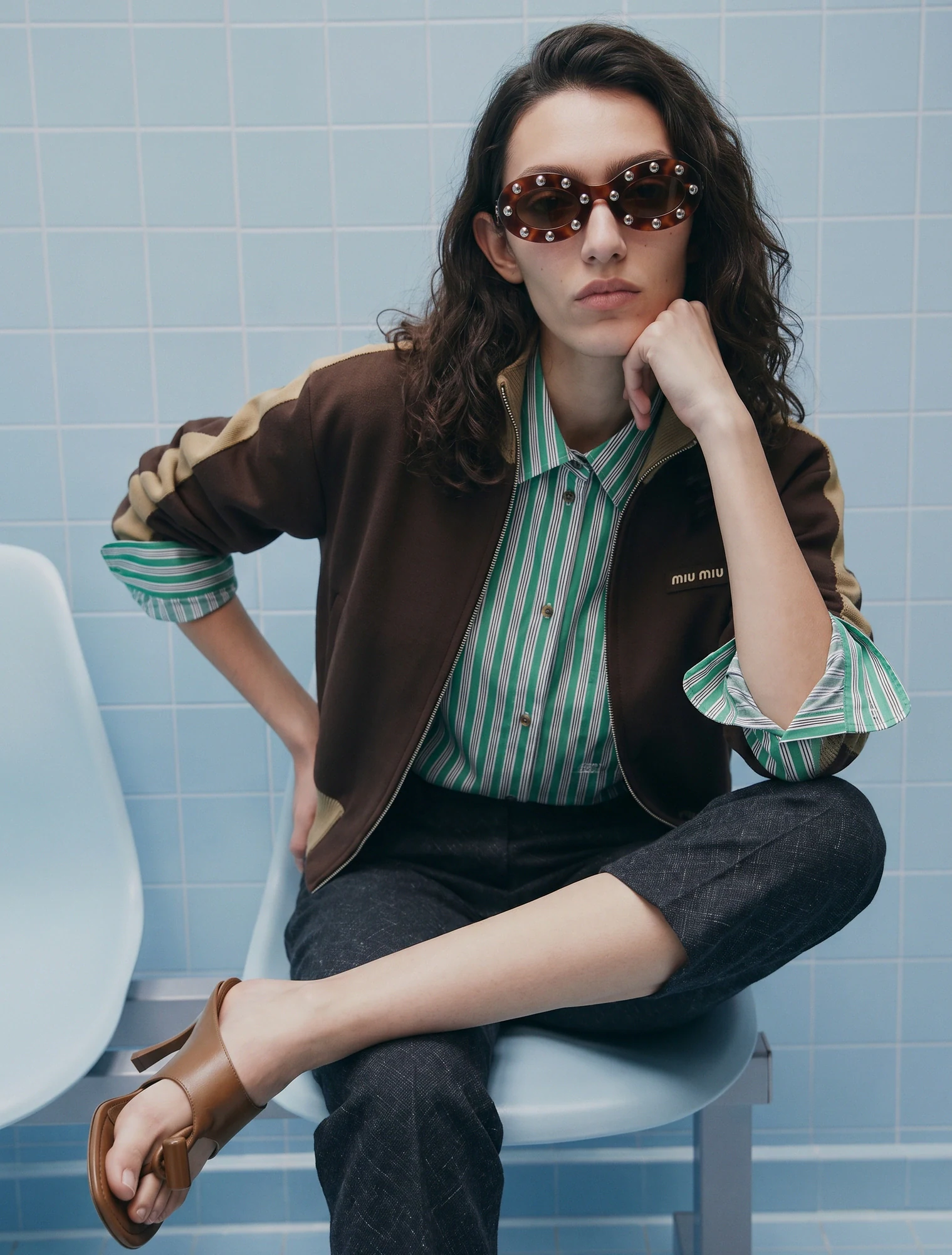 AI-generated on-model image: striped shirt under a bomber on a tiled interior set