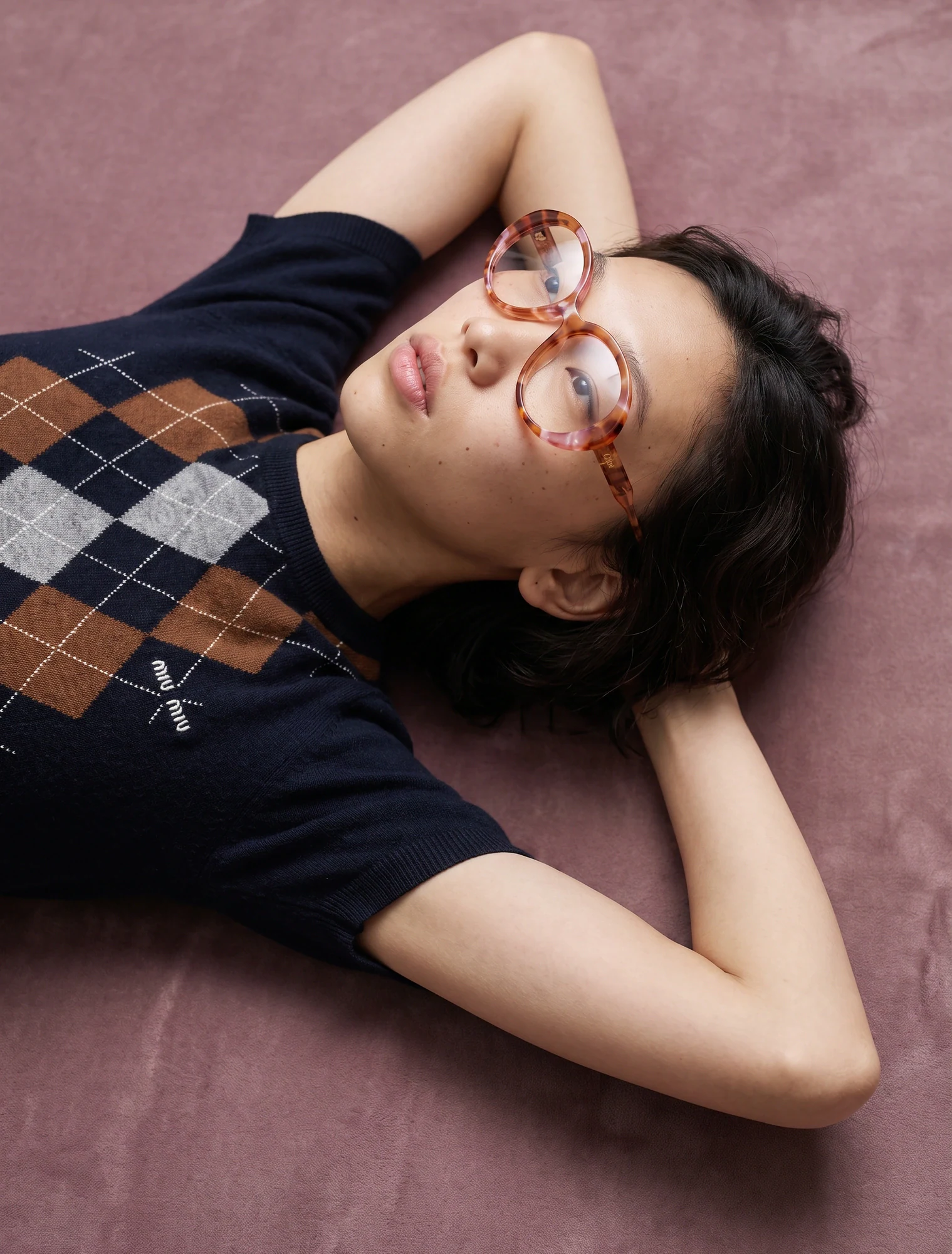 AI-generated on-model image: argyle knit and sculptural eyewear, overhead frame