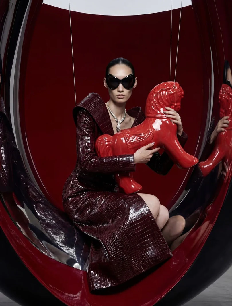 AI-generated on-model image: red lacquered coordinates on a sculptural red set