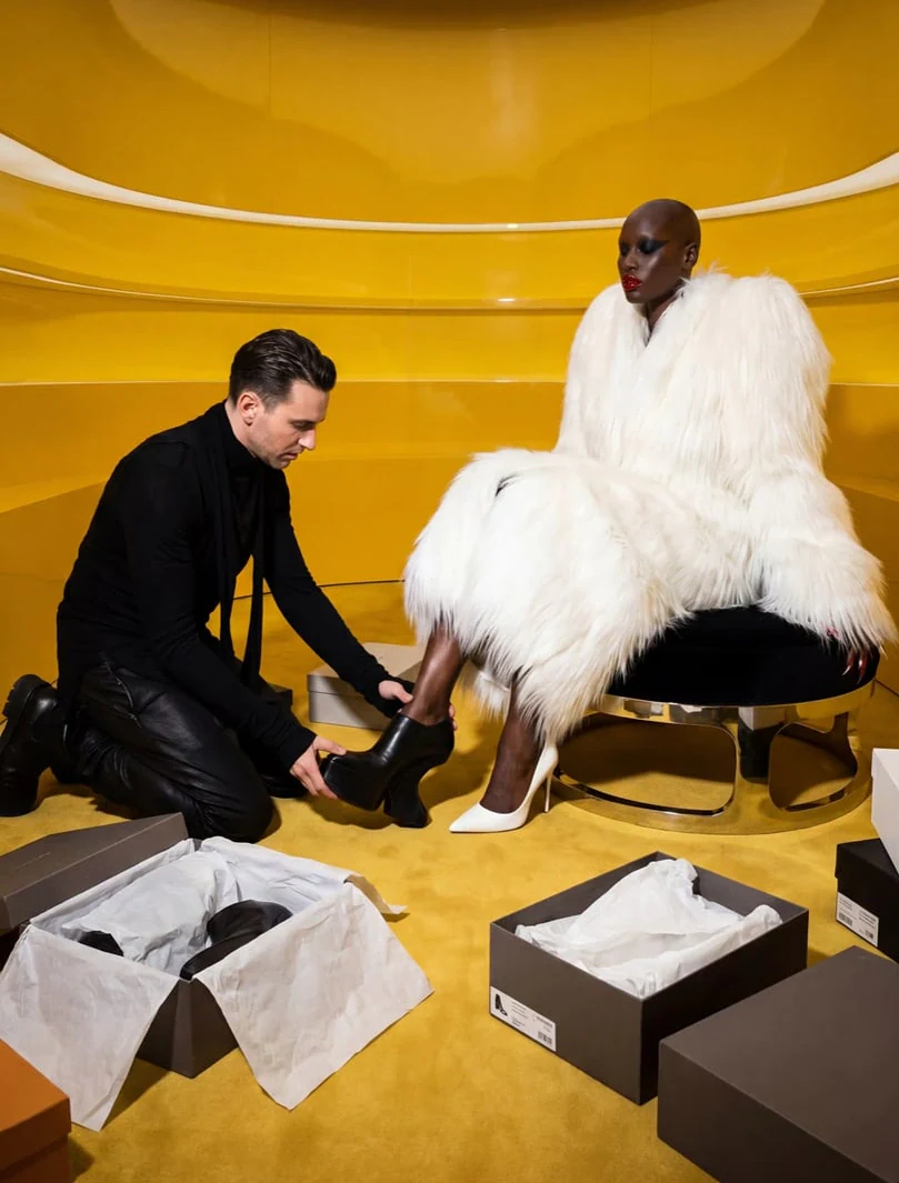 AI-generated on-model image: a fur coat being styled on a yellow studio set
