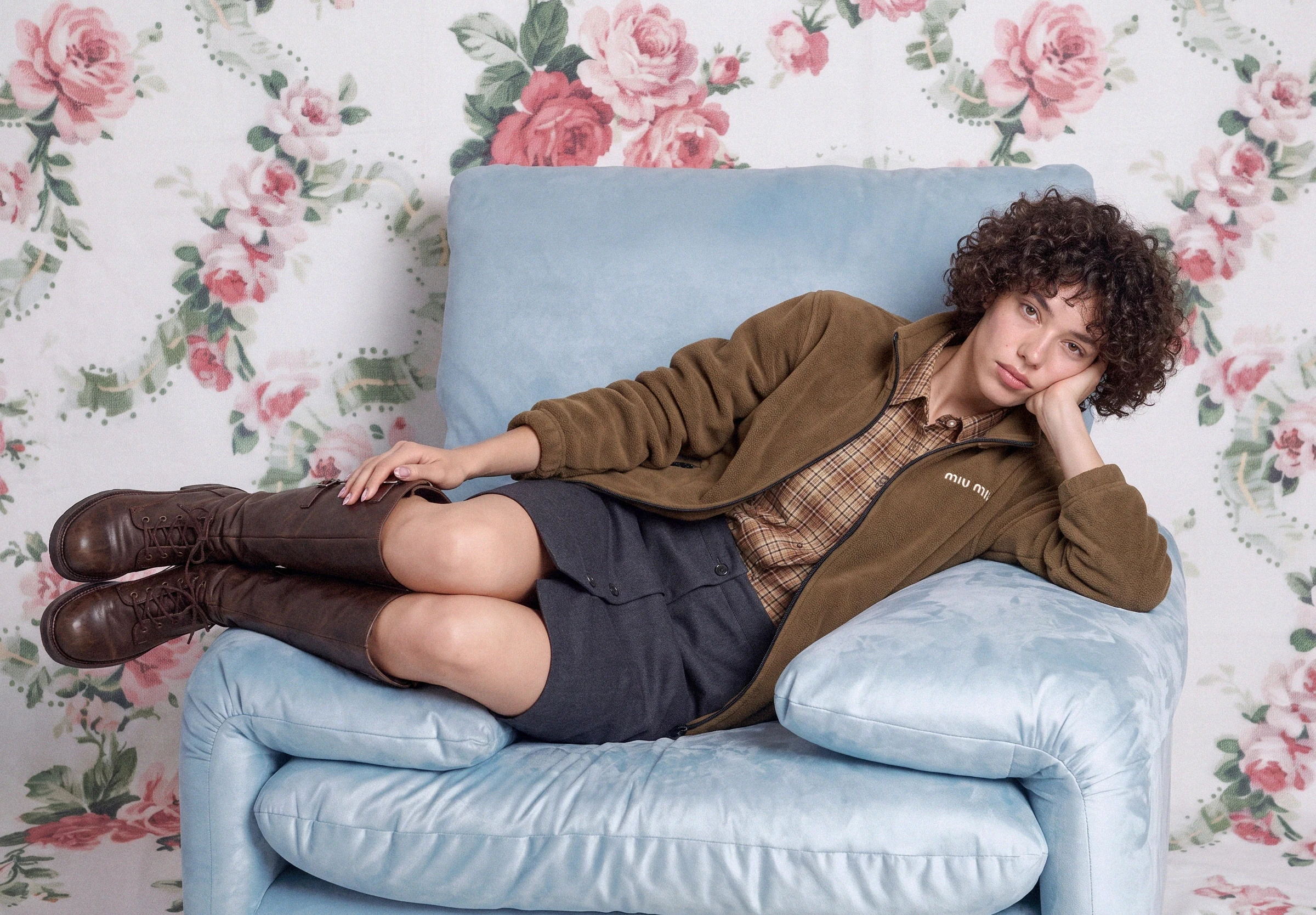 AI-generated on-model image: suede jacket and boots on a floral interior set, wide frame