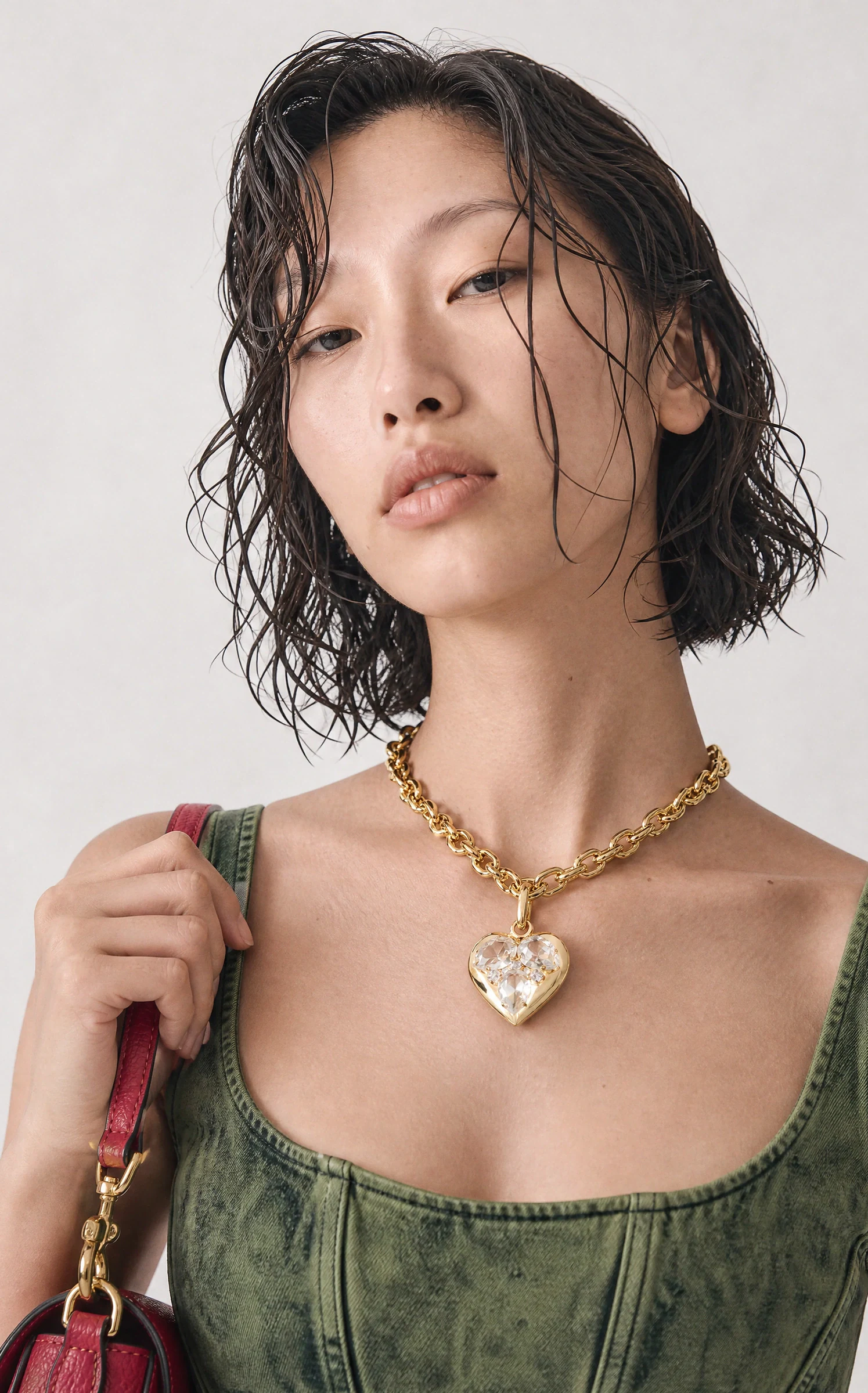 Maison Aro campaign frame — green corset top shot close on a studio backdrop