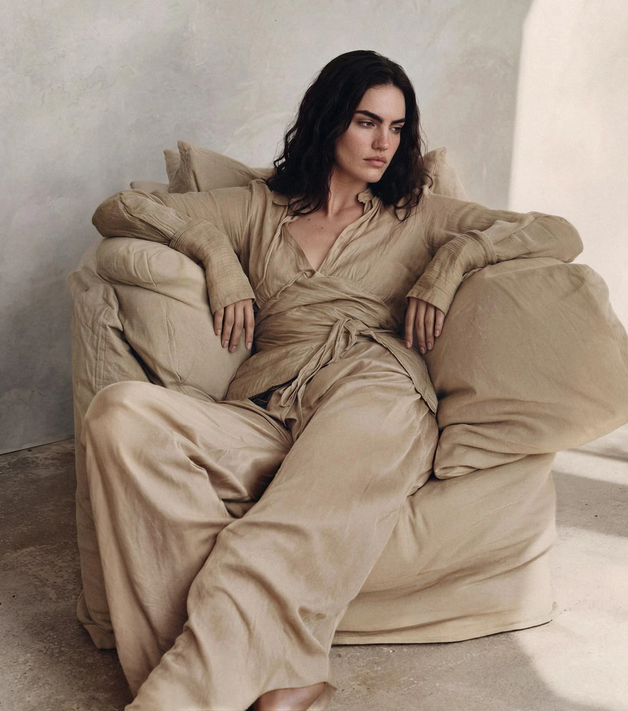 The same AI model wearing a linen lounge set in a new scene