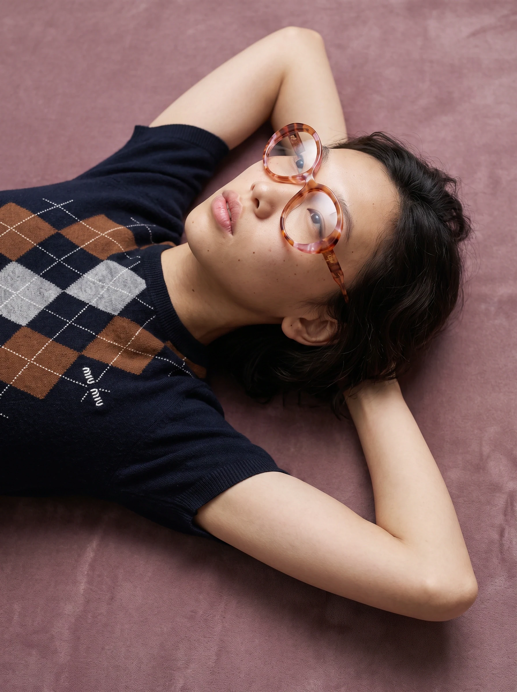 Argyle sweater on an AI fashion model, still frame from an editorial film