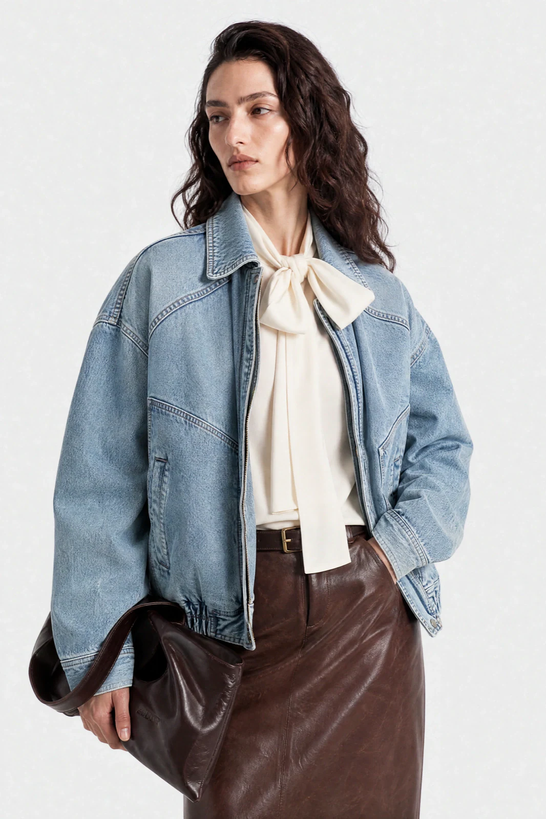 On-model photo generated from a flat lay: denim jacket styled as studio editorial