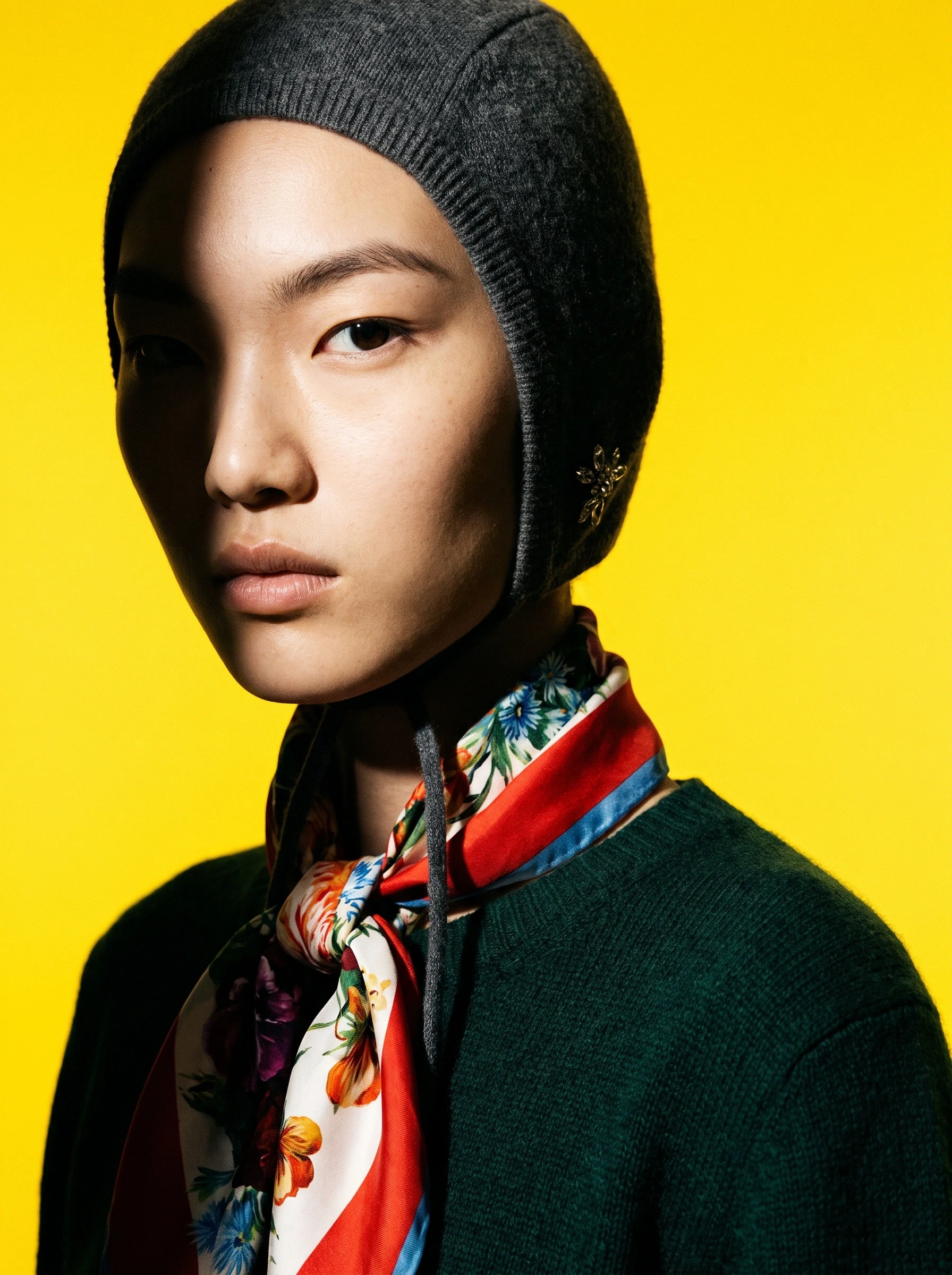 Embroidered knit sweater worn by an AI fashion model in soft editorial light