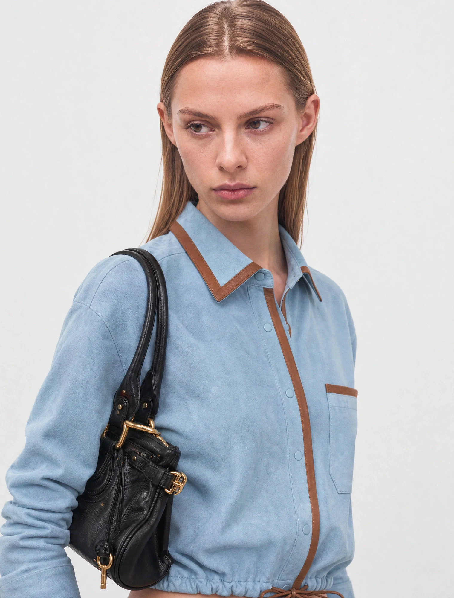 AI-generated on-model image: chambray overshirt with a leather bag, close-up portrait