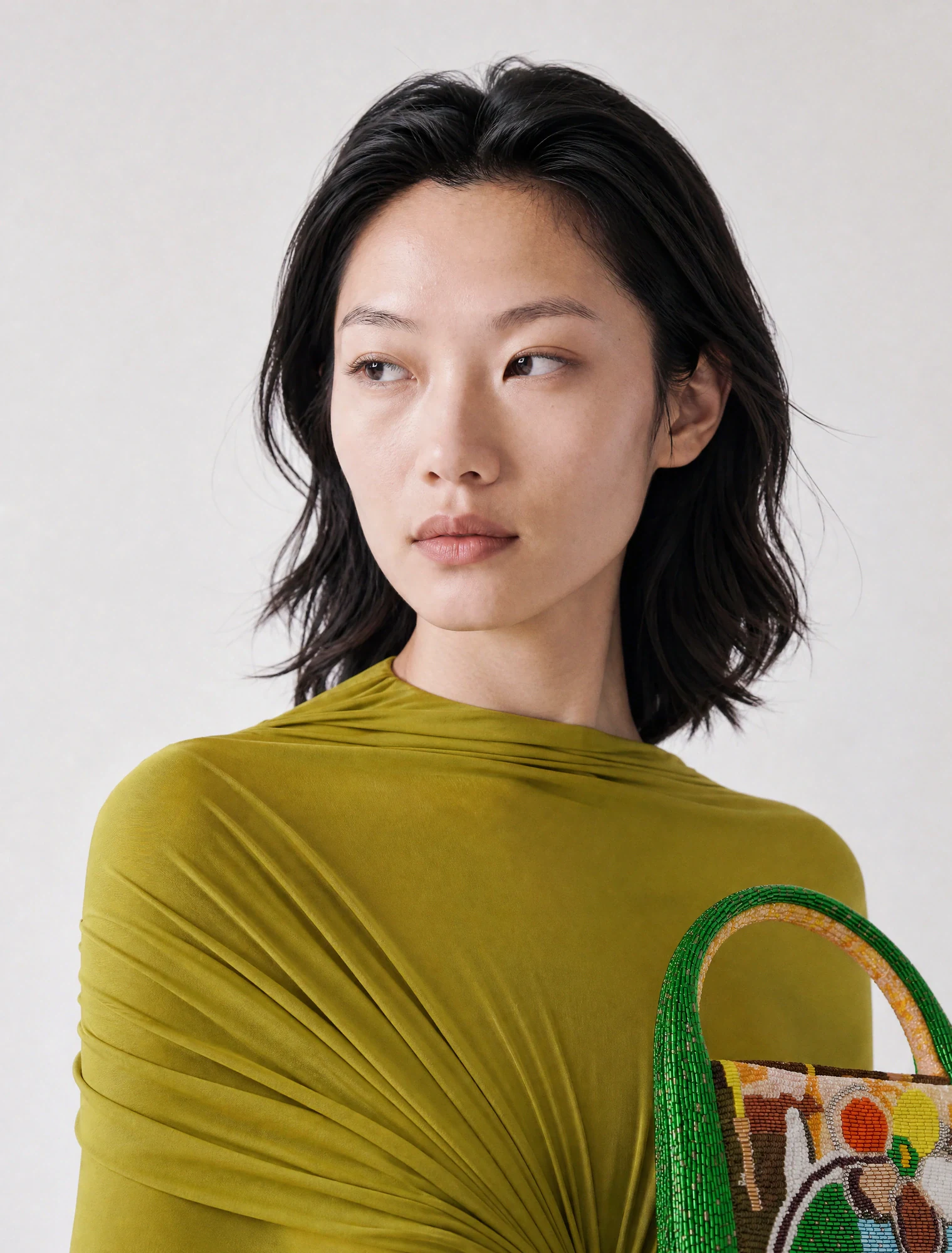 AI-generated on-model image: olive draped jersey dress, close-up portrait