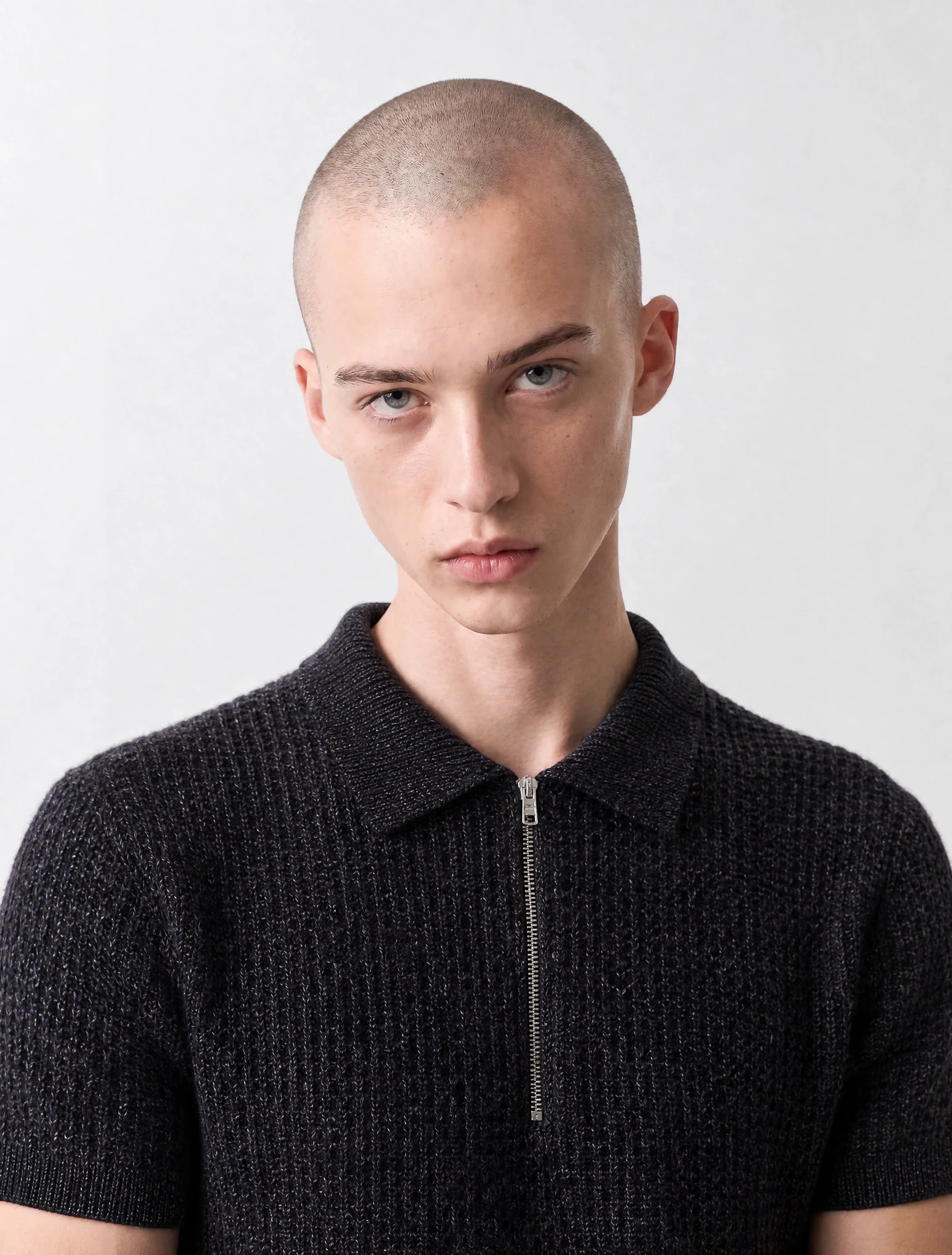 AI-generated on-model image: black textured knit polo on a male model, close-up portrait