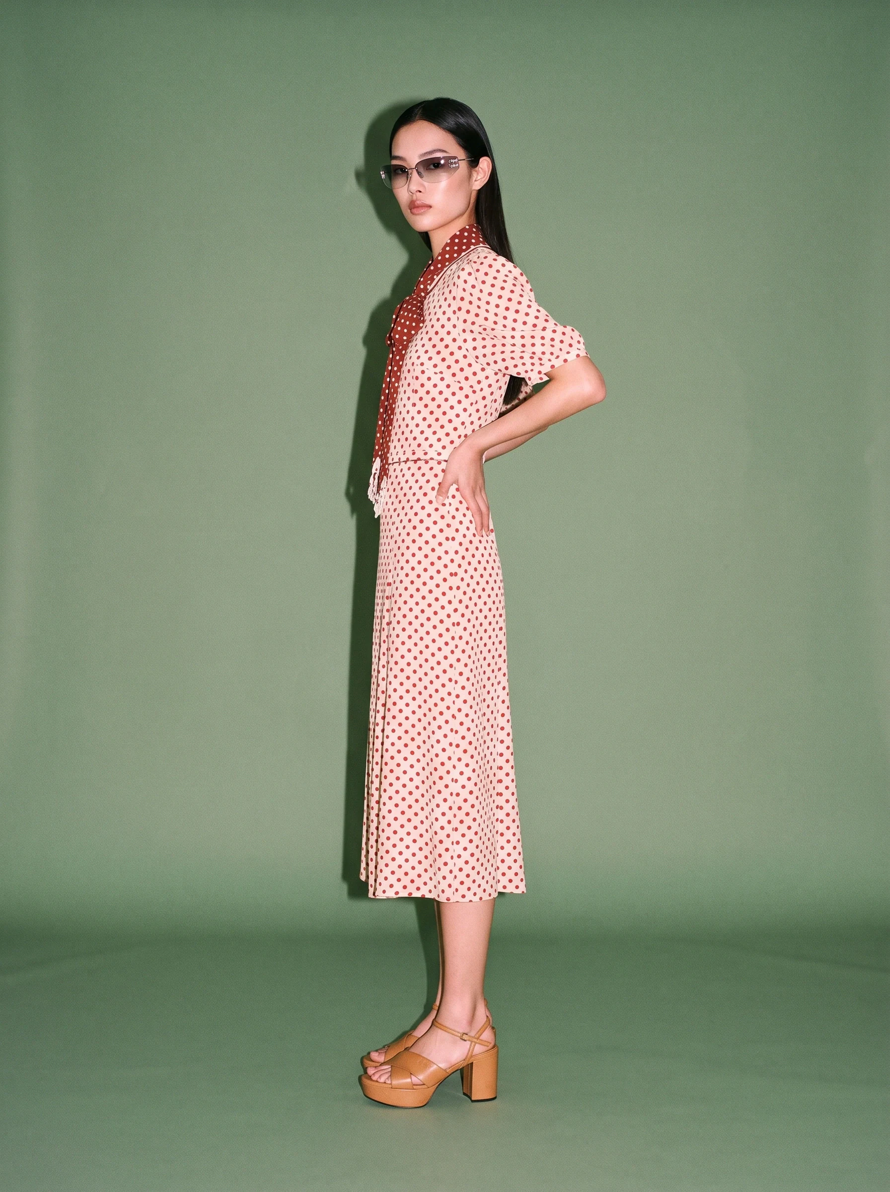 Polka-dot dress on an AI fashion model, still frame from a runway video