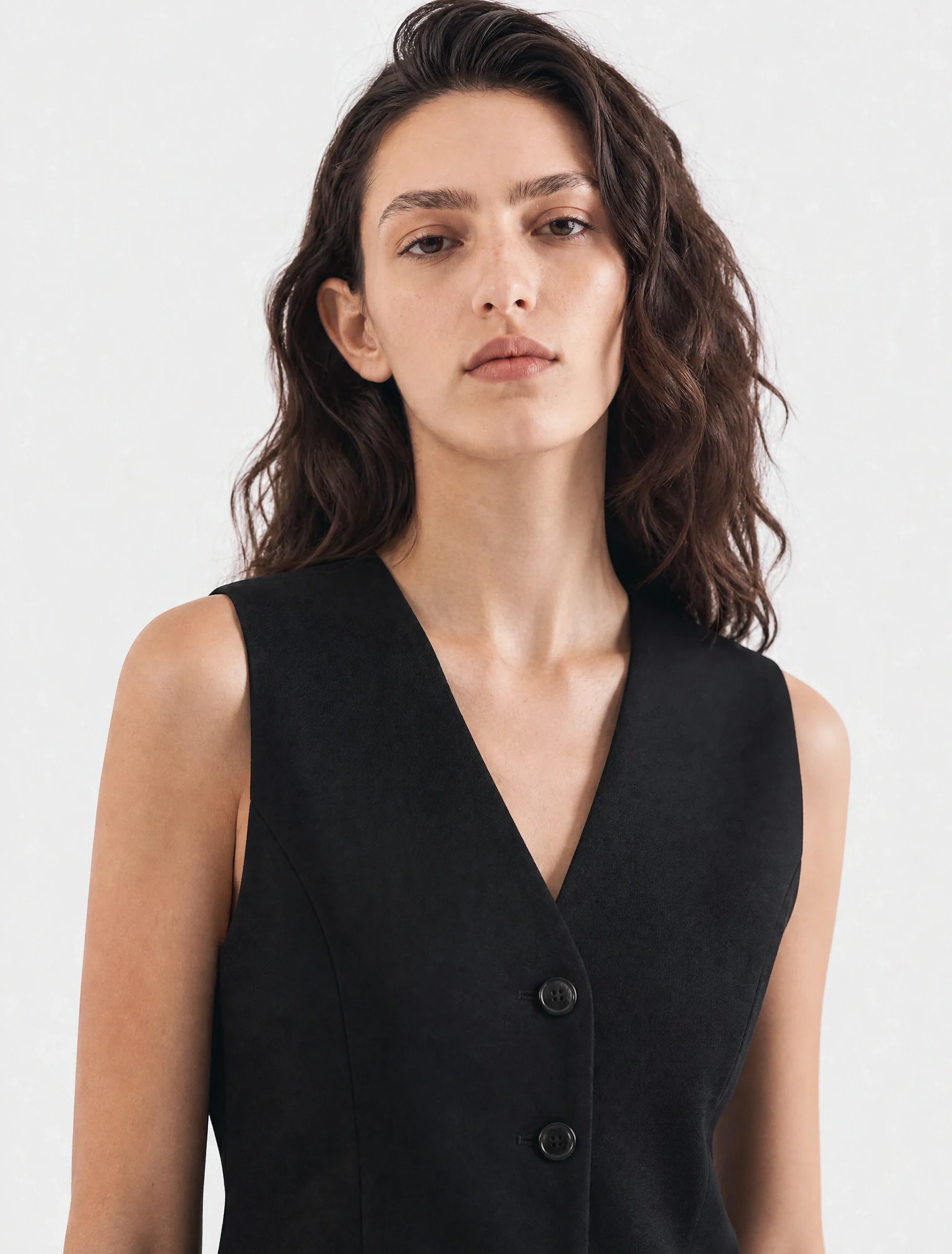 AI-generated on-model image: black tailored waistcoat, front mid shot on studio grey