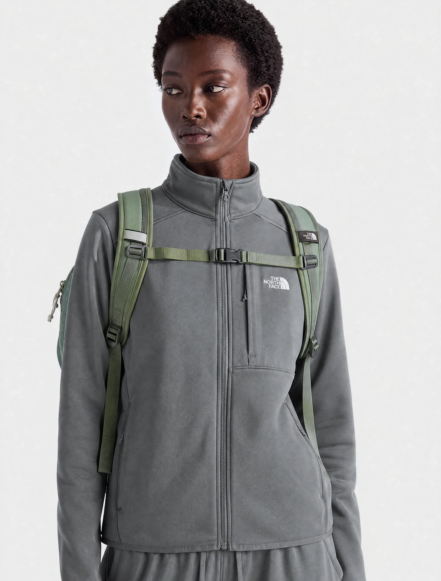 AI-generated on-model image: grey performance fleece jacket with a backpack