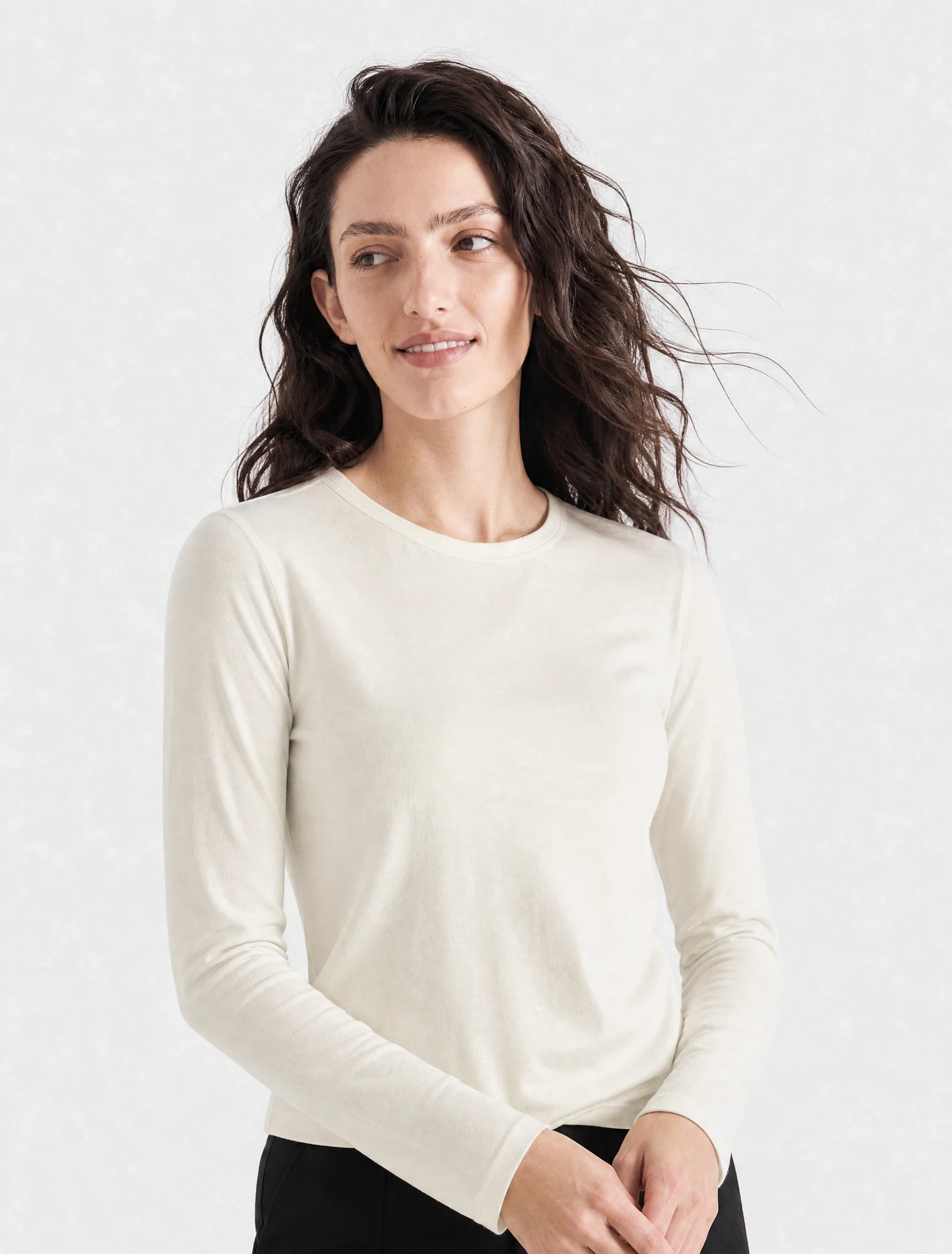 AI-generated on-model image: ivory fine-gauge knit with black trousers