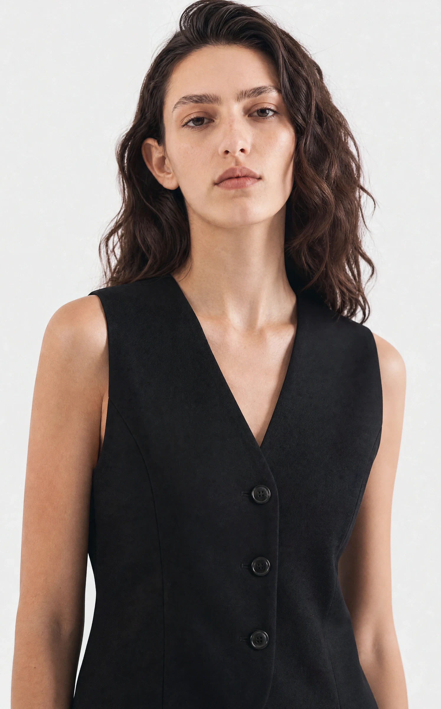 Maison Aro PDP close-up of the black tailored vest neckline and buttons